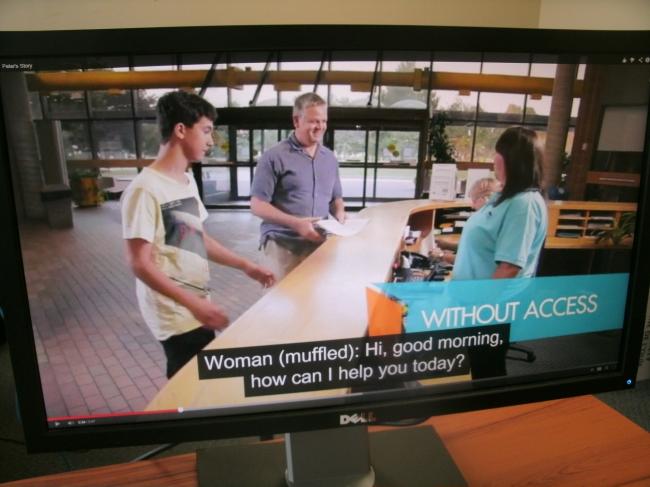 Closed captioning of a video. A video snapshot of three people at a reception desk.