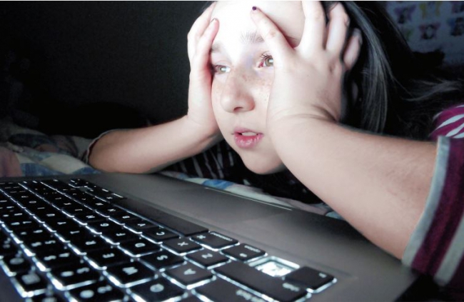 A young person in front of a computer. A young person in front of a computer.