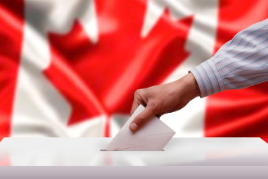 Voting in Canada. Voting in Canada, a hand puts a ballot in a box.